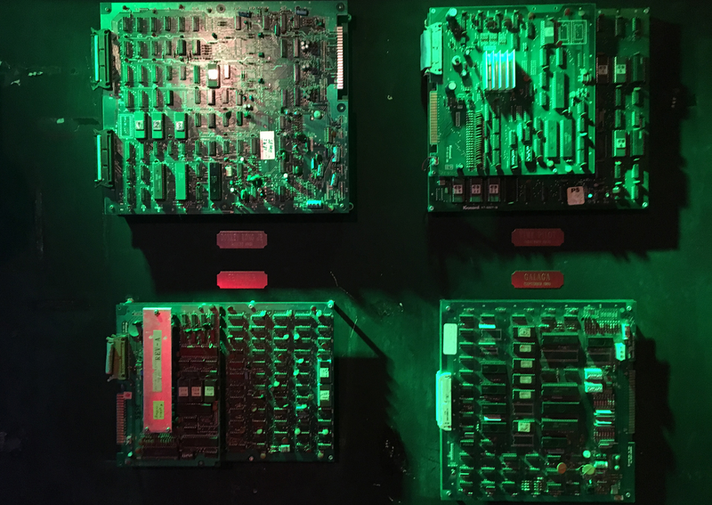 Circuit boards from arcade games like Donkey Kong Jr. and Galaga are displayed on the wall at Space Station.